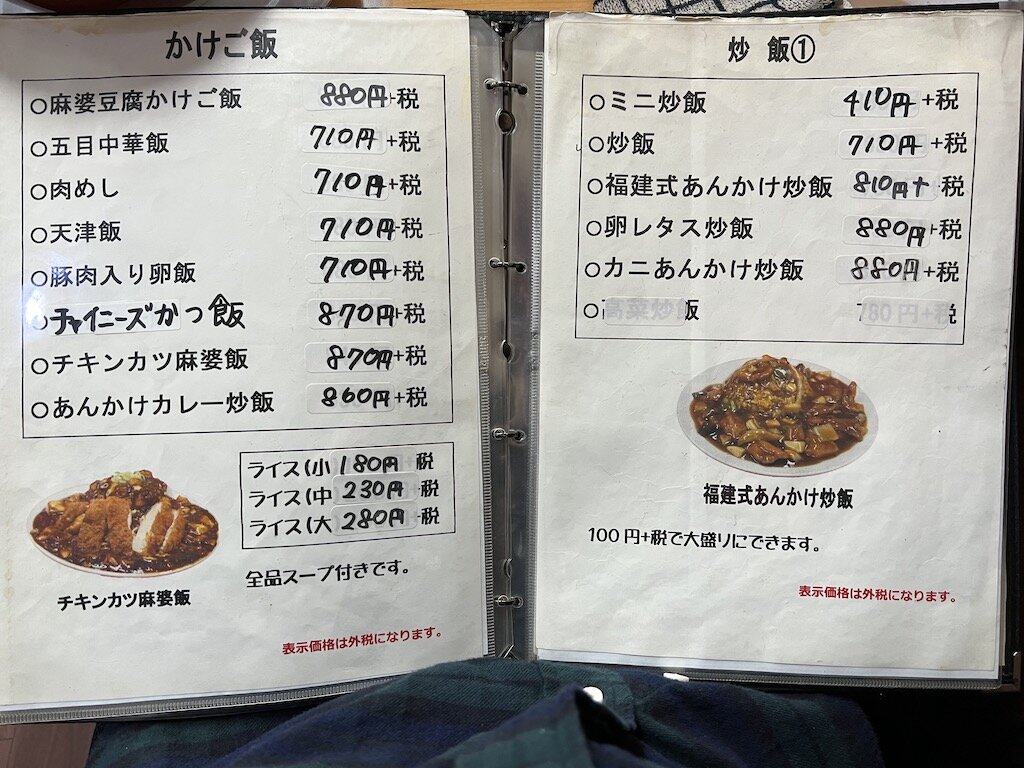 左ページの下の写真が「チキンカツ麻婆飯」（価格は2022年3月のもの）